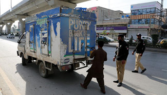 Pakistani policemen check vehicles at check point in Rawalpindi