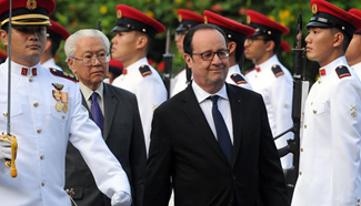Singapore's president and French counterpart attend welcome ceremony in Singapore