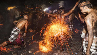 Men take part in sacred battle of fire before Nyepi in Indonesia