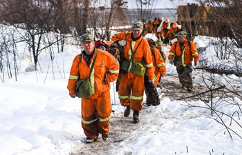 Firefighters on standby after heavy snowfall hits forest fire site in N China
