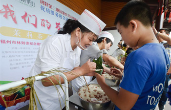 Children learn to make Zongzi in preparation for Dragon Boat Festival