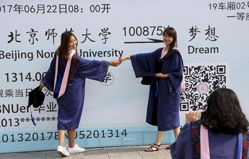 Graduates pose for photos at Beijing Normal University