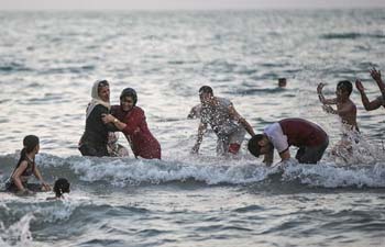 People enjoy themselves at Caspian sea beach in Iran