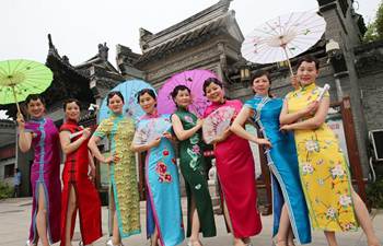 People present qipao dresses at park in E China's Zhejiang