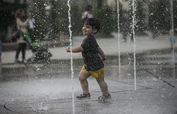 People cool off themselves as heat wave hits Tehran, Iran