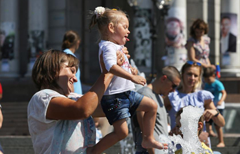 People cool off at fountain in Kiev, Ukraine