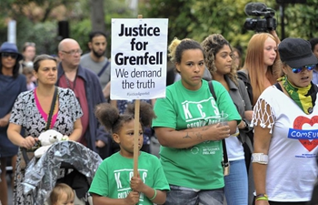 People march to pay respects to victims of Grenfell Tower fire