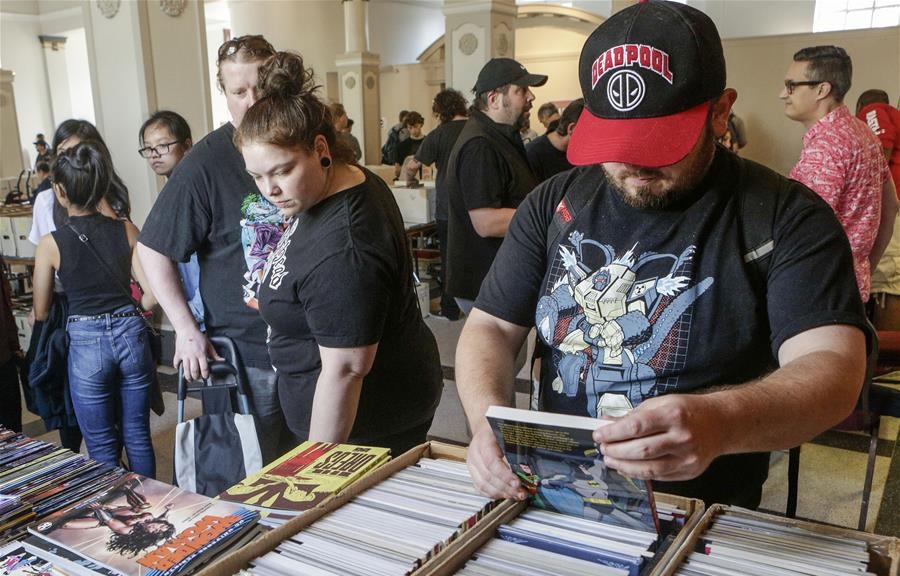 People view vintage comic books at comic book convention in Vancouver