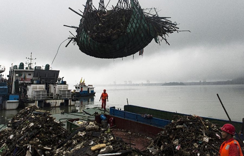 Sanitary workers clean rubbish at Three Gorges in China's Hubei