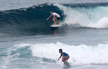 Tourists surf waves in water of Siargao Island