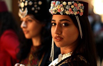 Models present traditional Armenian costumes in Jordan