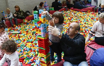 People play with Lego bricks at Lego bricklive convention in Brussels