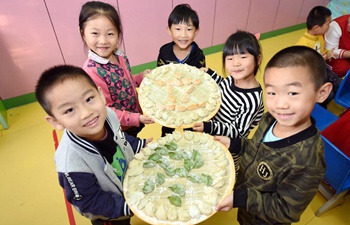 Children make dumplings to celebrate Beginning of Winter in N China