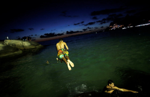 巴西进入盛夏：暮色降临海水颜色瑰丽夜泳享受美景