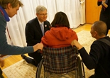 加拿大驻华大使半跪在地与女士交流